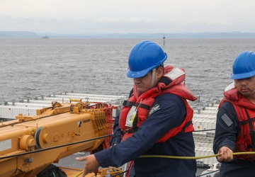 Sailors aboard the USS John Finn conduct an ammo onload in Yokosuka, Japan