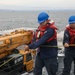 Sailors aboard the USS John Finn conduct an ammo onload in Yokosuka, Japan