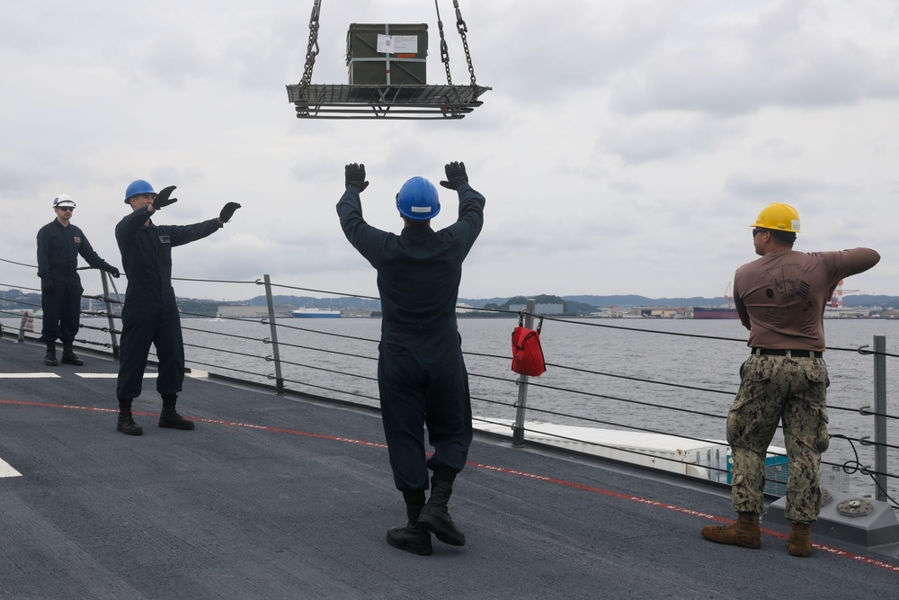 Sailors aboard the USS John Finn conduct an ammo onload in Yokosuka, Japan