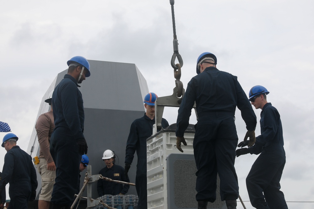 Sailors aboard the USS John Finn conduct an ammo onload in Yokosuka, Japan