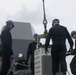 Sailors aboard the USS John Finn conduct an ammo onload in Yokosuka, Japan