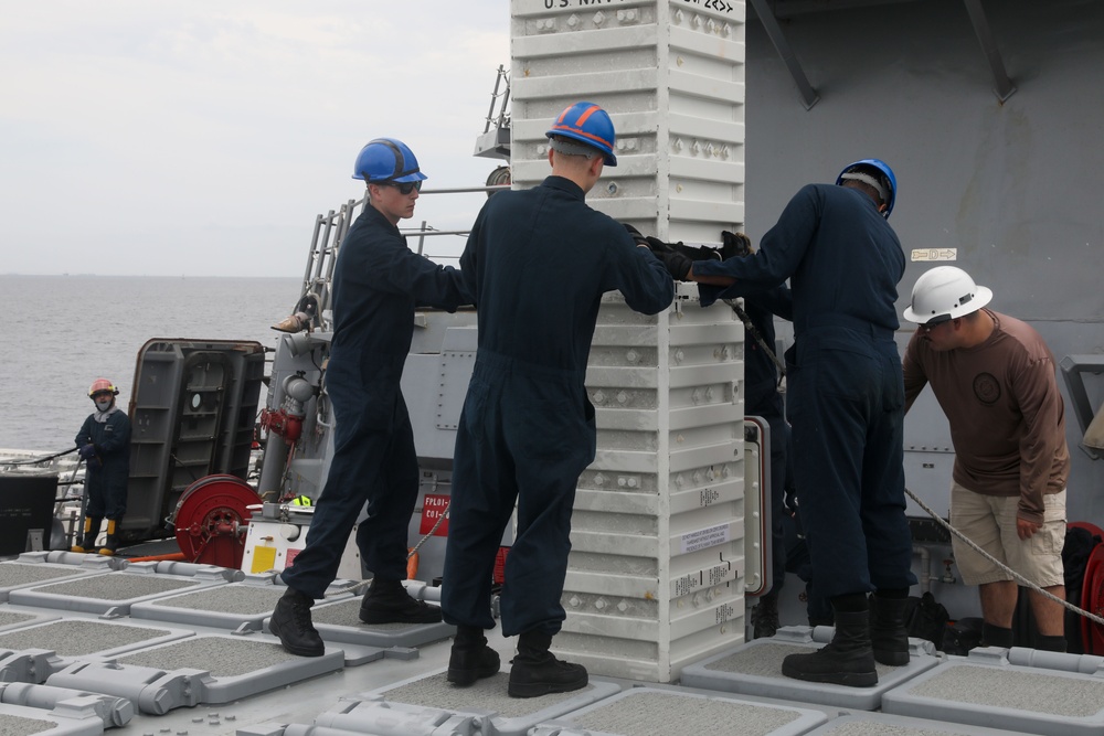 Sailors aboard the USS John Finn conduct an ammo onload in Yokosuka, Japan