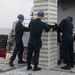 Sailors aboard the USS John Finn conduct an ammo onload in Yokosuka, Japan