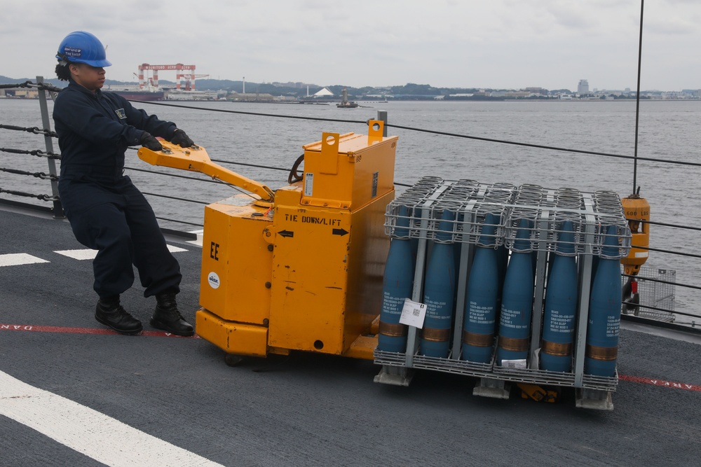 Sailors aboard the USS John Finn conduct an ammo onload in Yokosuka, Japan