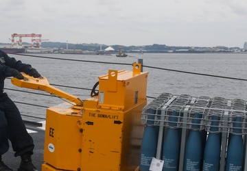 Sailors aboard the USS John Finn conduct an ammo onload in Yokosuka, Japan