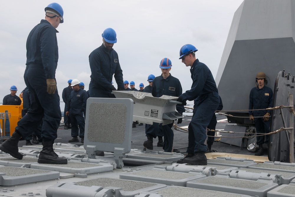 Sailors aboard the USS John Finn conduct an ammo onload in Yokosuka, Japan