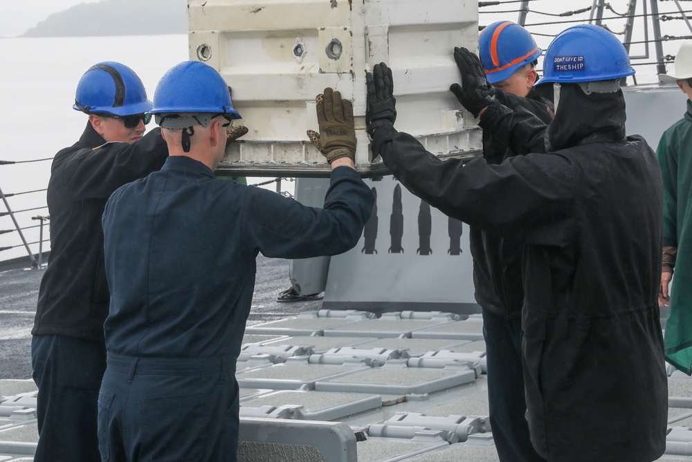 Sailors aboard the USS John Finn conduct an ammo onload in Yokosuka, Japan