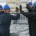 Sailors aboard the USS John Finn conduct an ammo onload in Yokosuka, Japan