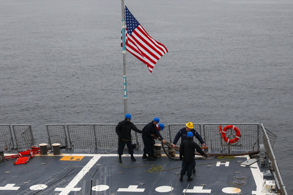 Sailors aboard the USS John Finn conduct an ammo onload in Yokosuka, Japan