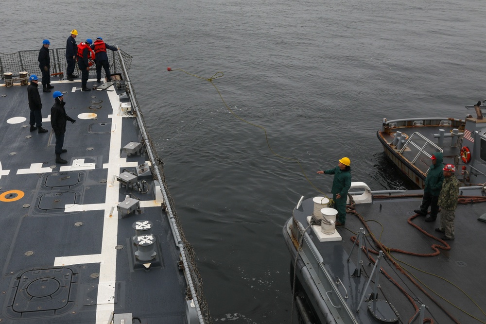 Sailors aboard the USS John Finn conduct an ammo onload in Yokosuka, Japan