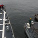 Sailors aboard the USS John Finn conduct an ammo onload in Yokosuka, Japan