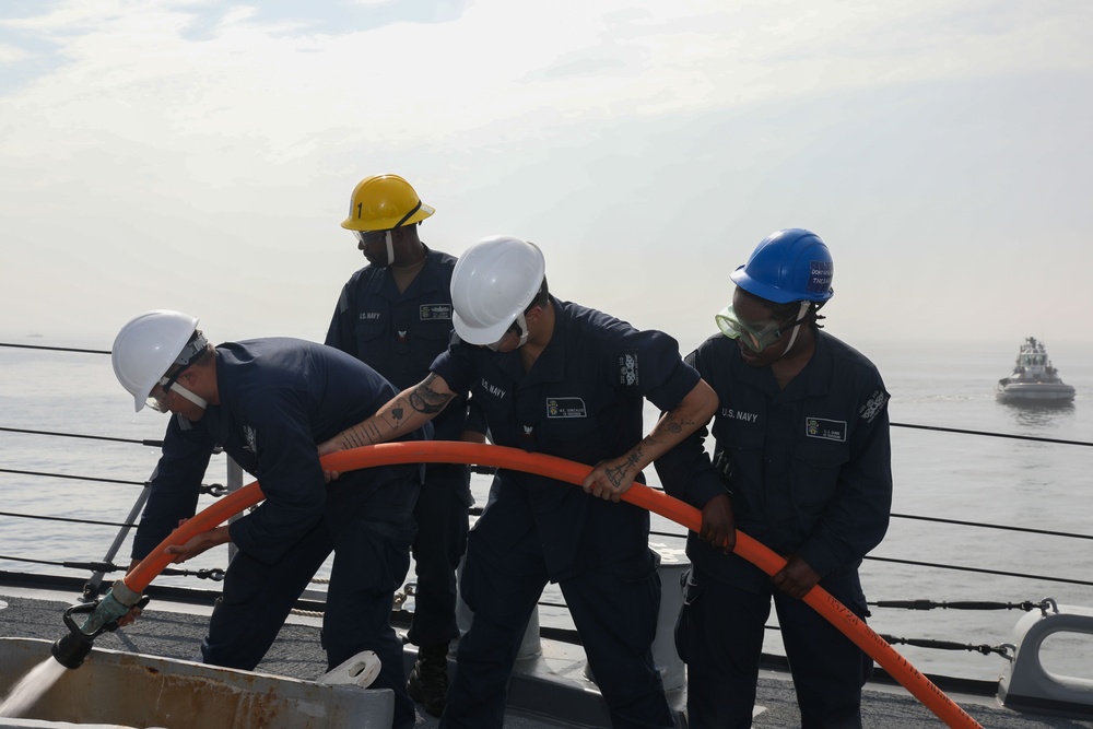 Sailors aboard the USS John Finn conduct a sea and anchor detail in Yokosuka, Japan