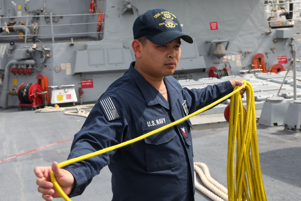 Sailors aboard the USS John Finn conduct a sea and anchor detail in Yokosuka, Japan