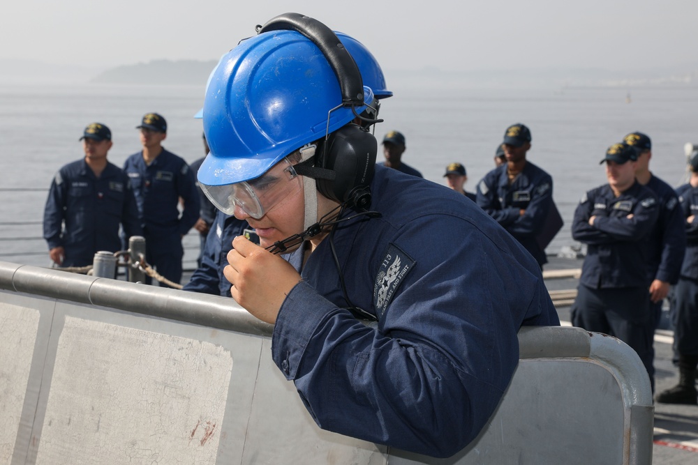 Sailors aboard the USS John Finn conduct a sea and anchor detail in Yokosuka, Japan
