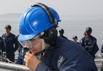 Sailors aboard the USS John Finn conduct a sea and anchor detail in Yokosuka, Japan