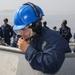 Sailors aboard the USS John Finn conduct a sea and anchor detail in Yokosuka, Japan