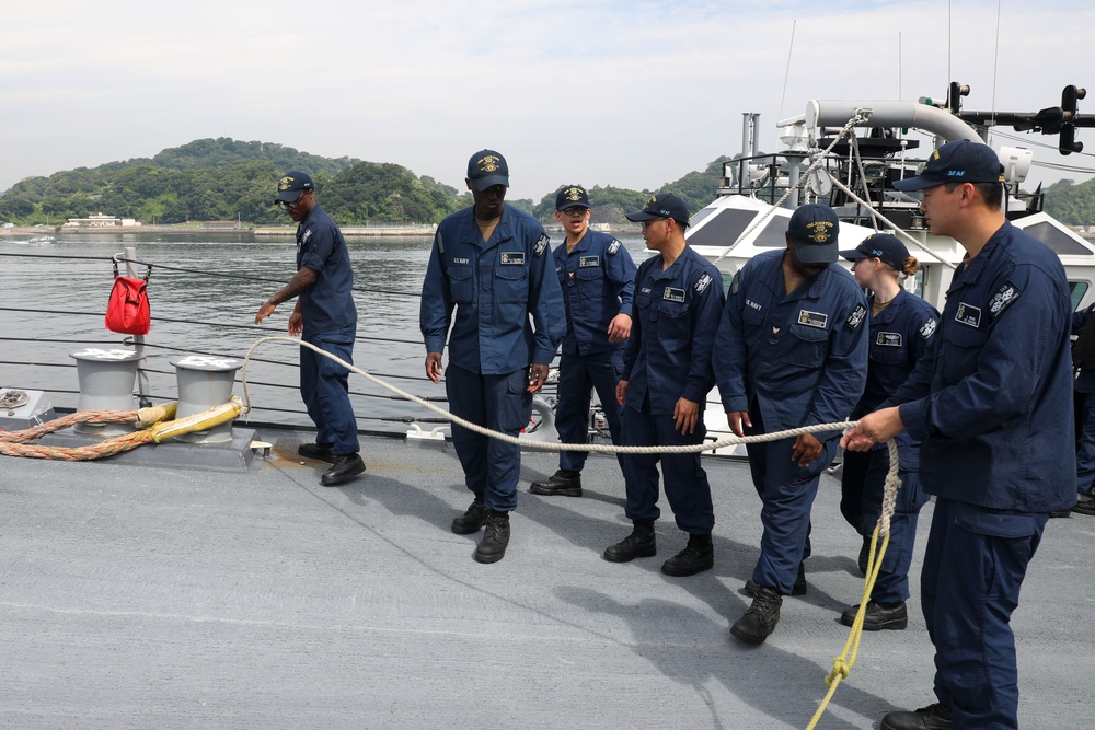 Sailors aboard the USS John Finn conduct a sea and anchor detail in Yokosuka, Japan