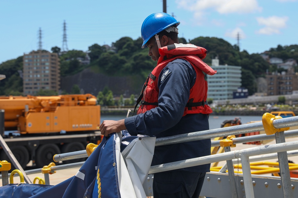 Sailors aboard the USS John Finn conduct a sea and anchor detail in Yokosuka, Japan