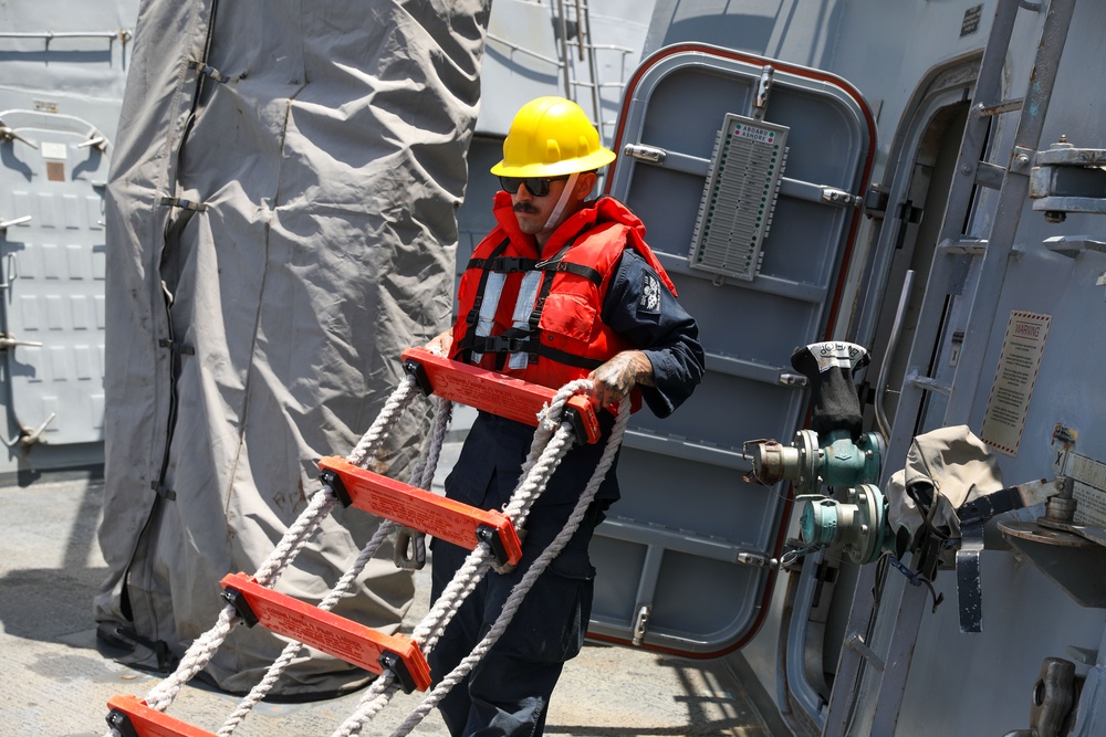 Sailors aboard the USS John Finn conduct a sea and anchor detail in Yokosuka, Japan