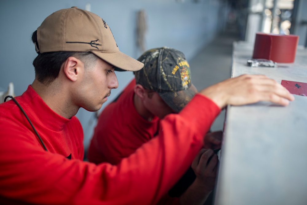 Sailors Reload Chaff Launchers Aboard USS Tripoli