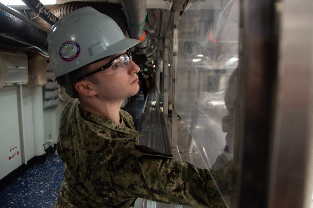 Ronald Reagan Sailor Cleans Glass