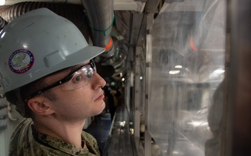 Ronald Reagan Sailor Cleans Glass