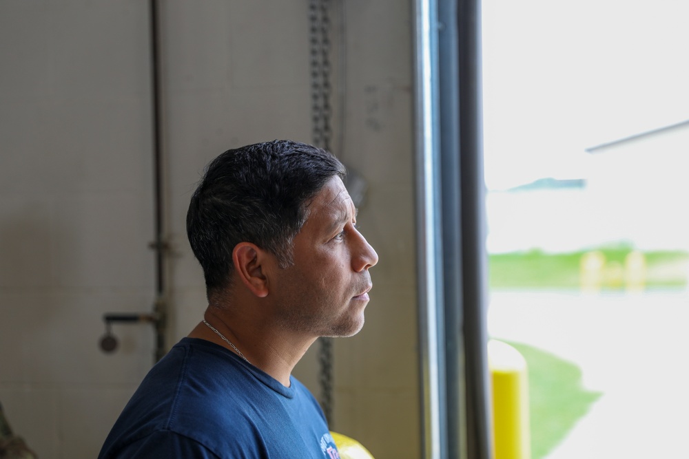 Captain Gregory Cruz listening to his firemen explain operations