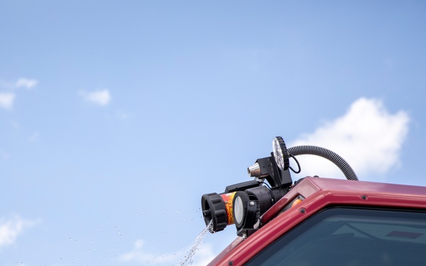 Firefighter Adam Burkholder operates the aircraft rescue and firefighting striker