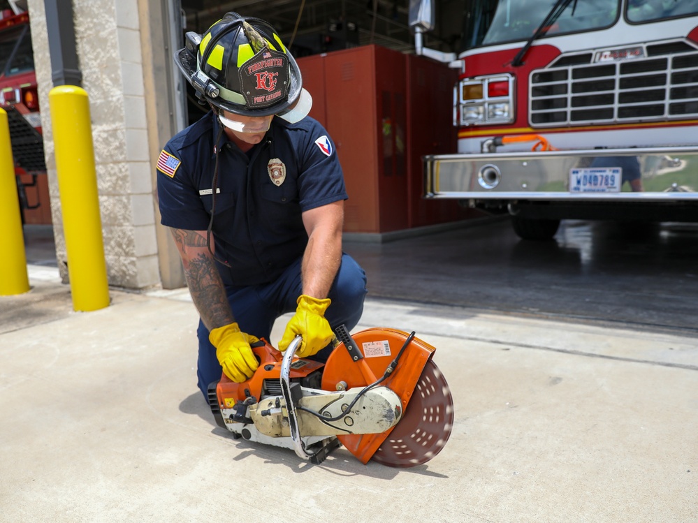 Firefighter Adam Burkholder uses the metal saw