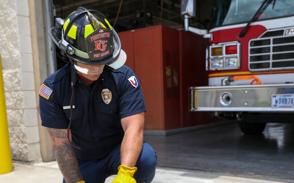 Firefighter Adam Burkholder uses the metal saw