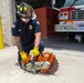 Firefighter Adam Burkholder uses the metal saw