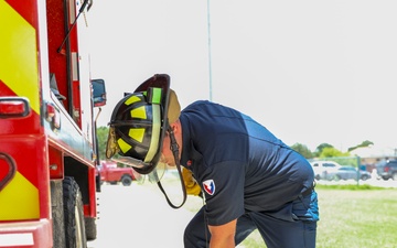 Firefighter Adam Burkholder cranks chainsaw to test operations