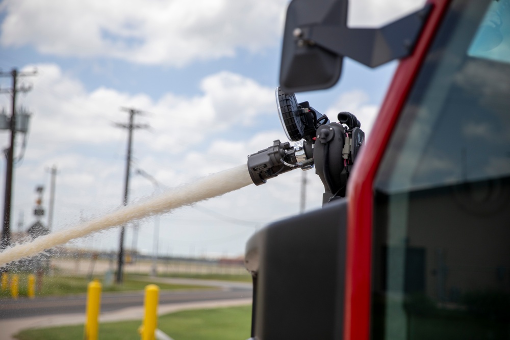 Firefighter Adam Burkholder operates the aircraft rescue and firefighting striker