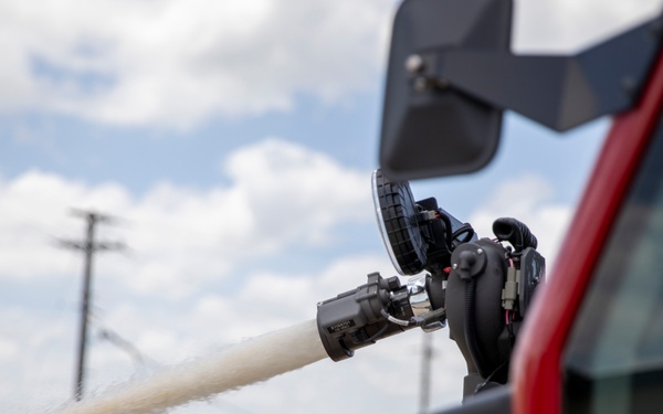 Firefighter Adam Burkholder operates the aircraft rescue and firefighting striker