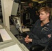Sailors aboard the USS John Finn conduct watch in front of the Electric Plant Control Console in the Philippine Sea