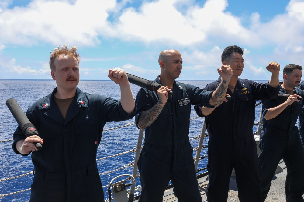 Sailors aboard the USS John Finn conduct a security reaction force class in the Philippine Sea