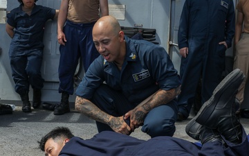 Sailors aboard the USS John Finn conduct a security reaction force class in the Philippine Sea