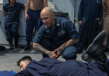 Sailors aboard the USS John Finn conduct a security reaction force class in the Philippine Sea