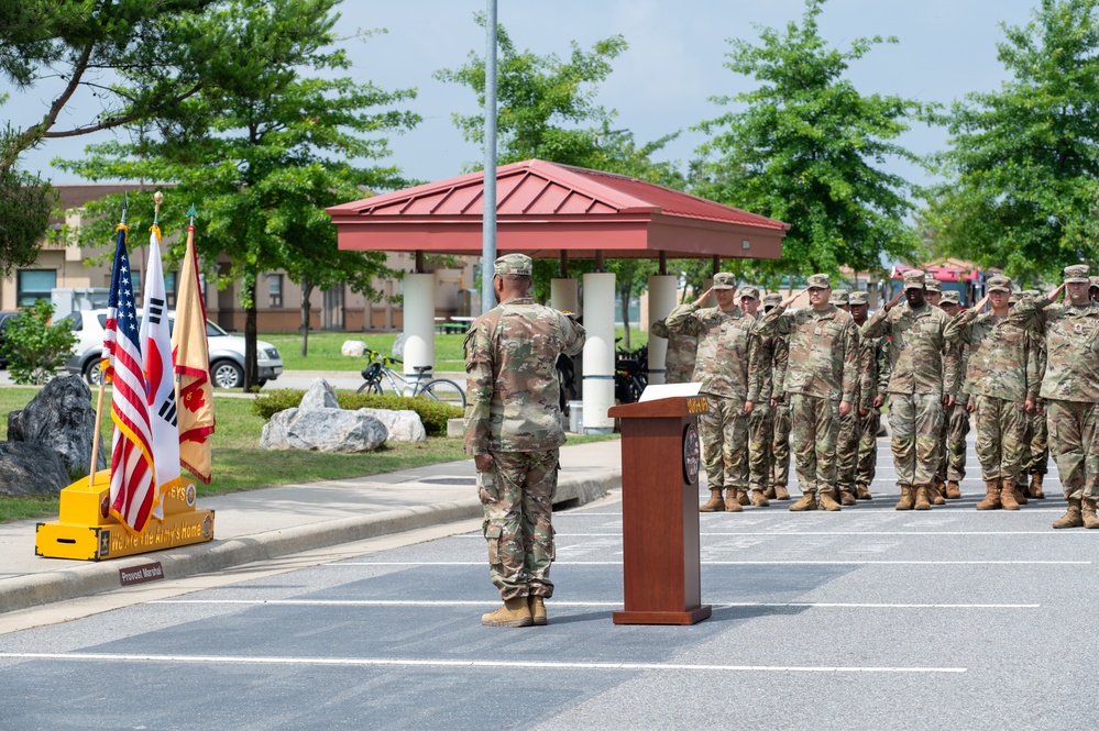 Soldiers salute the flag