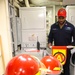DC1 Anthony Monroe posts with a signal flag during a damage control training
