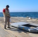 BMC Evandare Aganon aligns the rapid securing device during flight operations