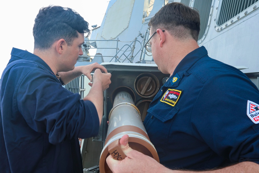 CTT2 Thomas Kerr and CTTC Michael Gaffney verify the lot number of MK214 chaff rounds