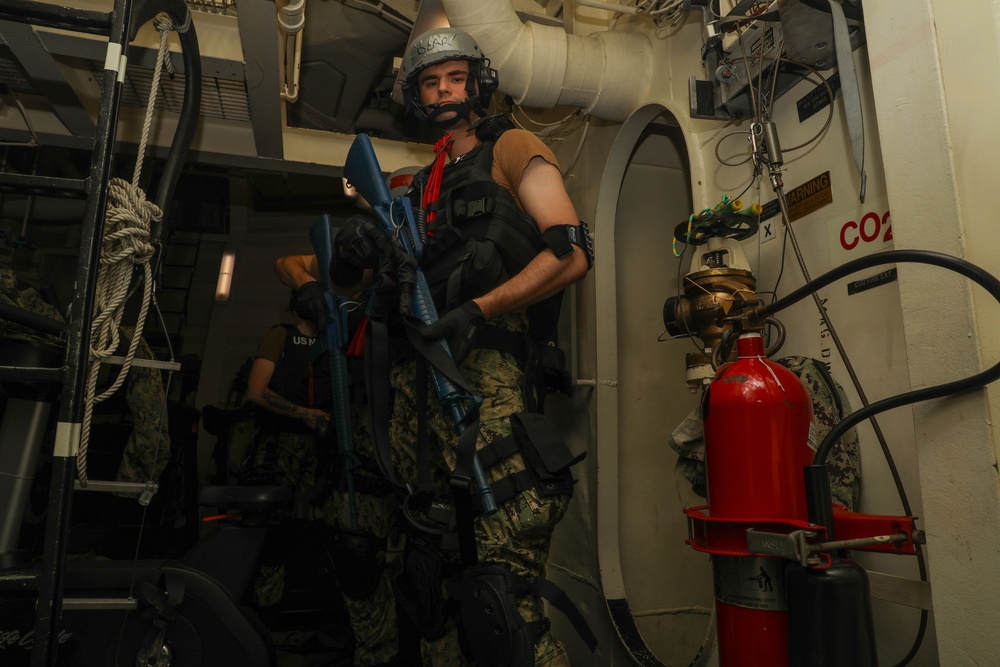 Sailors aboard the USS John Finn conduct a visit, board, search, and seizure drill in the Philippine Sea