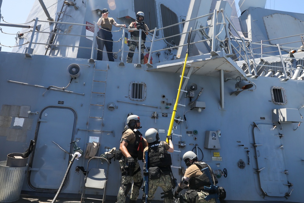 Sailors aboard the USS John Finn conduct a visit, board, search and seizure drill in the Philippine Sea