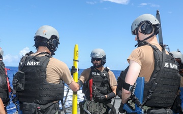 Sailors aboard the USS John Finn conduct a a visit, board, search and seizure drill in the Philippine Sea