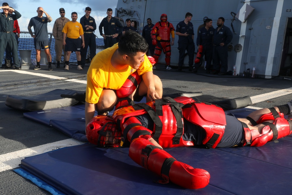 Sailors aboard the USS John Finn hold a security reaction force class in the Philippine Sea