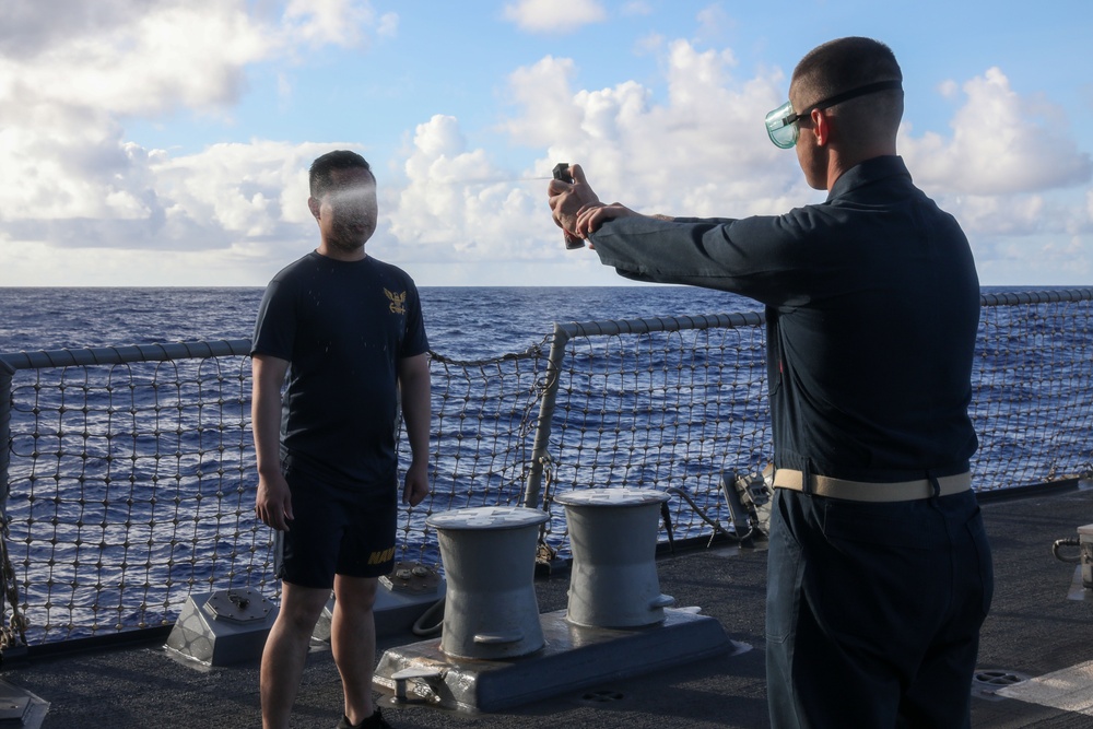 Sailors aboard the USS John Finn hold a security reaction force class in the Philippine Sea