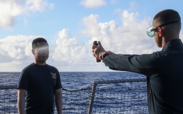 Sailors aboard the USS John Finn hold a security reaction force class in the Philippine Sea