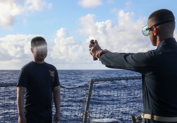 Sailors aboard the USS John Finn hold a security reaction force class in the Philippine Sea