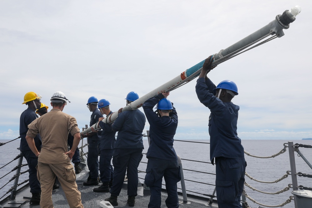 Sailors aboard the USS John Finn conduct a sea and anchor detail in Apra Harbor, Guam